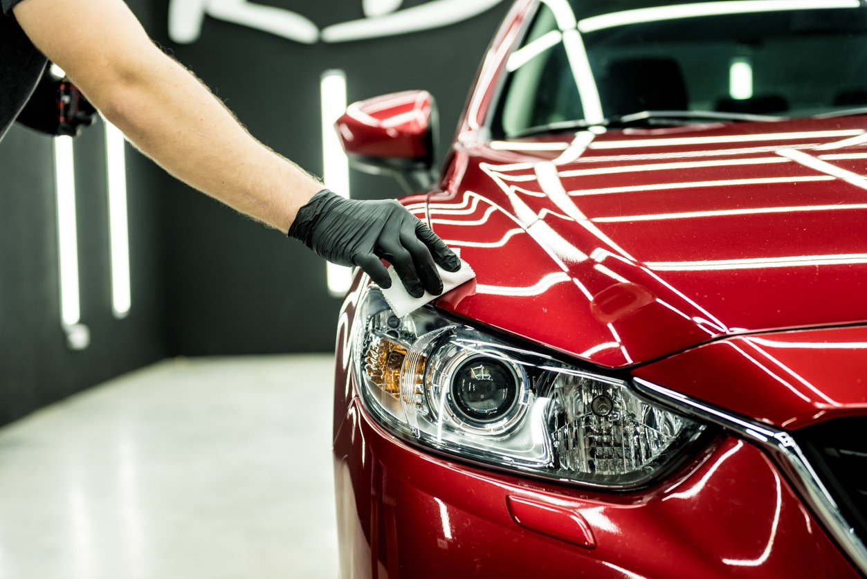 Freshly corrected red paint under studio lights at Vivid Detailing