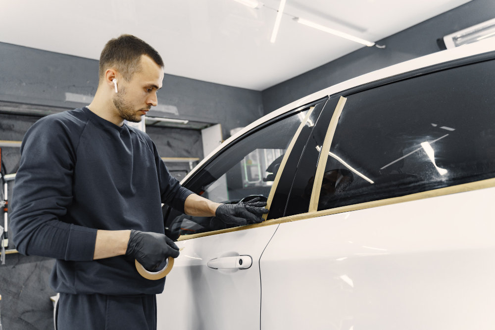Window tint installation on a white vehicle